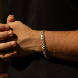 Man wearing 10MM solid silver Cuban link bracelet