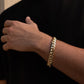 Man wearing 12MM 14KT gold over silver Cuban link bracelet