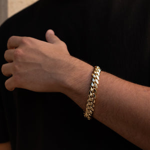 Man wearing 12MM 14KT gold over silver Cuban link bracelet
