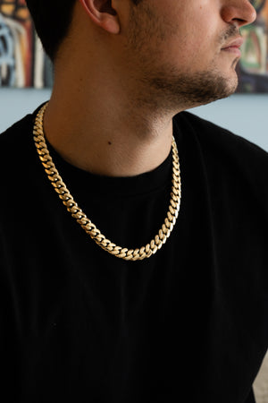 Man wearing 12MM 14KT gold over silver Cuban link chain