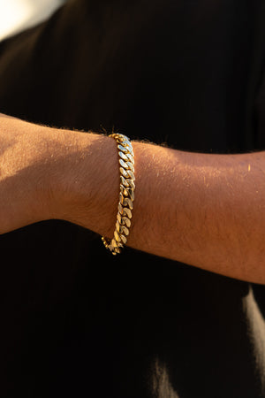 Man wearing 10MM 14KT gold over silver Cuban link bracelet
